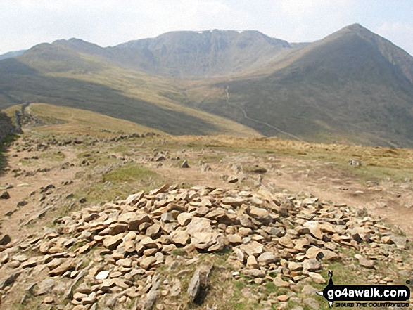 Walk c220 Helvellyn via Striding Edge from Glenridding - Birkhouse Moor summit cairn - with Striding Edge, Helvellyn, Swirral Edge and Catstye Cam beyond