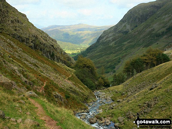 Walk c172 Scafell Pike via The Corridor Route from Wasdale Head, Wast Water - Looking down Styhead Gill from Sty Head to a sunlit Borrowdale  with Bleaberry Fell the high point in the distance