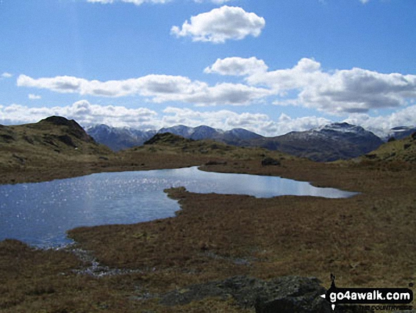 Walk c195 Castle How and Blea Rigg from Grasmere - Looking across an unnamed tarn below Great Castle How to Wetherlam and the Furness Fells