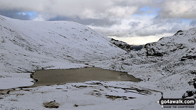 Walk c172 Scafell Pike via The Corridor Route from Wasdale Head, Wast Water - Sty Head Tarn with Base Brown beyond in the snow