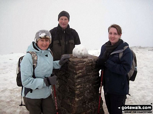 Bryan, Lorna and Ami Goodfellow on the summit of Pen-y-Ghent in the snow