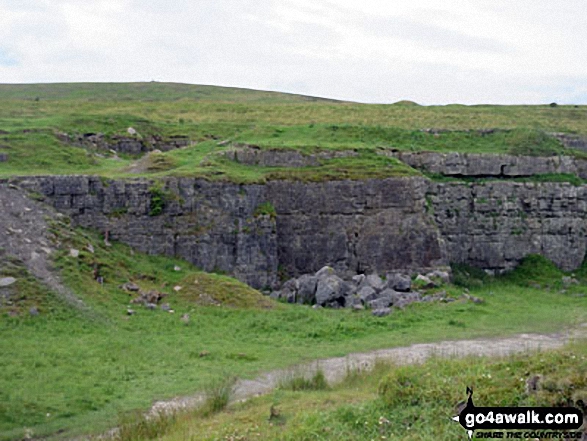 An old quarry with Faulds Brow summit on the horizon 