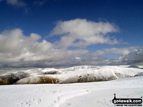 Looking East to the snowy fell tops of Stony Cove Pike (Caudale Moor) and High Street from the summit of Little Hart Crag 