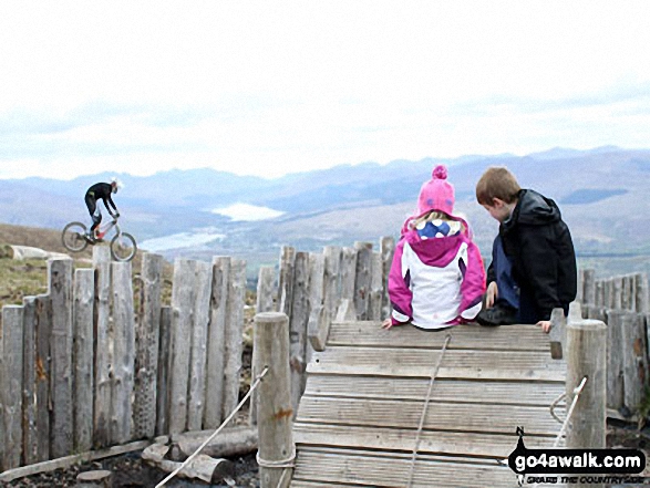 My little girl and her cousin watching the mountain bikers at the top of the Ski lift about half-way up Aonach Mor 