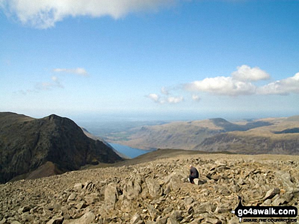 Walk c166 The Scafell Masiff from Wha House Farm, Eskdale - Lone fell walker on Scafell Pike with Symonds Knott and Sca Fell (left), Wast Water and Seatallen (right) beyond