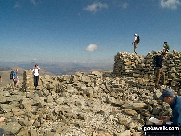 Walk c194 Scafell Pike from The Old Dungeon Ghyll, Great Langdale - Holding on to the Trig point on Scafell Pike summit