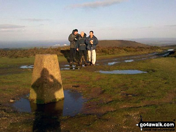 Black Hill trig point on the Quantocks. My shadow taking the photo, with Neil, Nick and Keith in the view. Hinkley Point power station in the background!