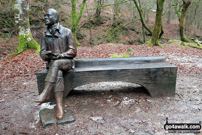 Statue to Robert Burns sitting on a bench in the Birks of Aberfeldy 