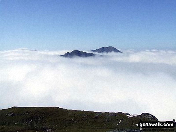 The summits of Ben Vane (left) and Beinn Ime poking up through the clouds during a temperature inversion seen from Ben Vorlich (The Arrochar Alps)