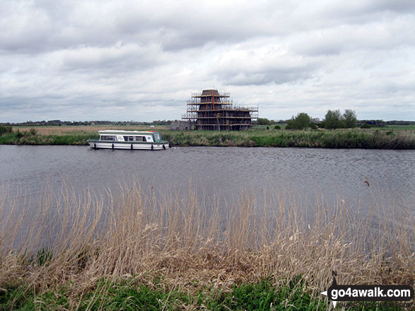 Boat on the River Bure with St Benet's Abbey Drainage Mill on the other side 