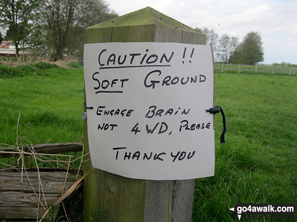 Sign by the side Palmer's Drainage Mill on the banks of Upton Dyke It says: Caution!! Soft Ground. Engage brain not 4 wheel drive please. Thank you.