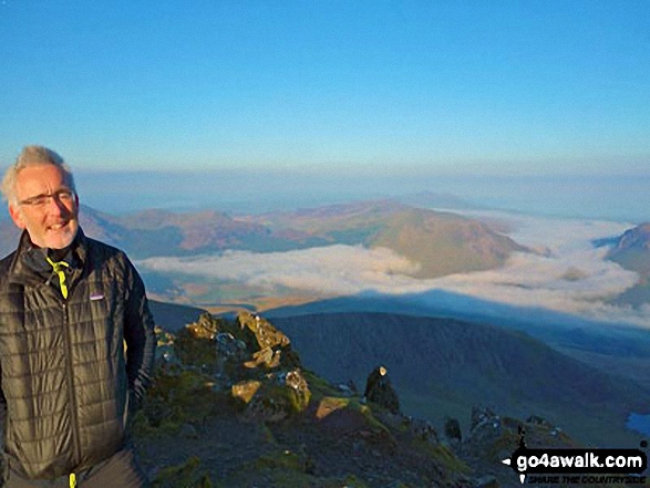 Walk gw136 The Snowdon (Yr Wyddfa) Horseshoe from Pen y Pass - My son in law Mark waking up on the top of Snowdon with fabulous clouds down below