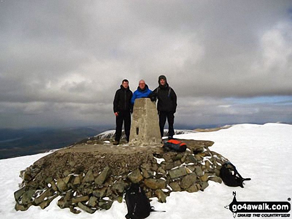 Walk h154 Ben Nevis and Carn Mor Dearg from The Nevis Range Mountain Gondola - On Ben Nevis summit trig point in the snow