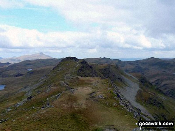 Cnicht (North Top) from Cnicht with Carnedd Moel Siabod  lit by sunlight in the distance (left) 