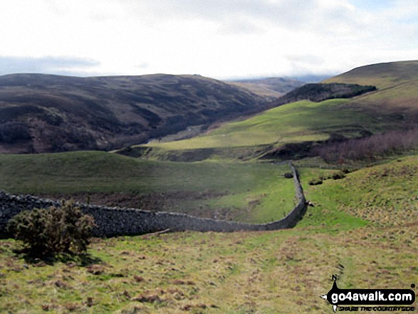 Walk n107 Wooler Common and Happy Valley (High Level Route) from Wooler - Descending into The Carey Burn Valley with Langlee Crags opposite from near Switcher Wood