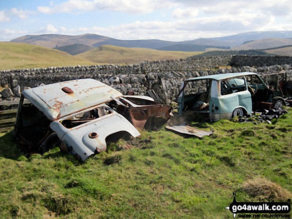 A couple of abandoned cars behind the sheepfold below Ring Chesters 