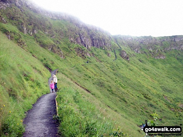 My daughter and I making our way on one of the paths that zigzag to the top of the cliffs overlooking the Giants Causeway 