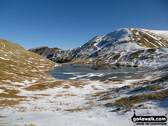 Walk c266 Seat Sandal and Fairfield from Grasmere - Grisedale Tarn in the snow with St Sunday Crag (centre left) and Fairfield (right)