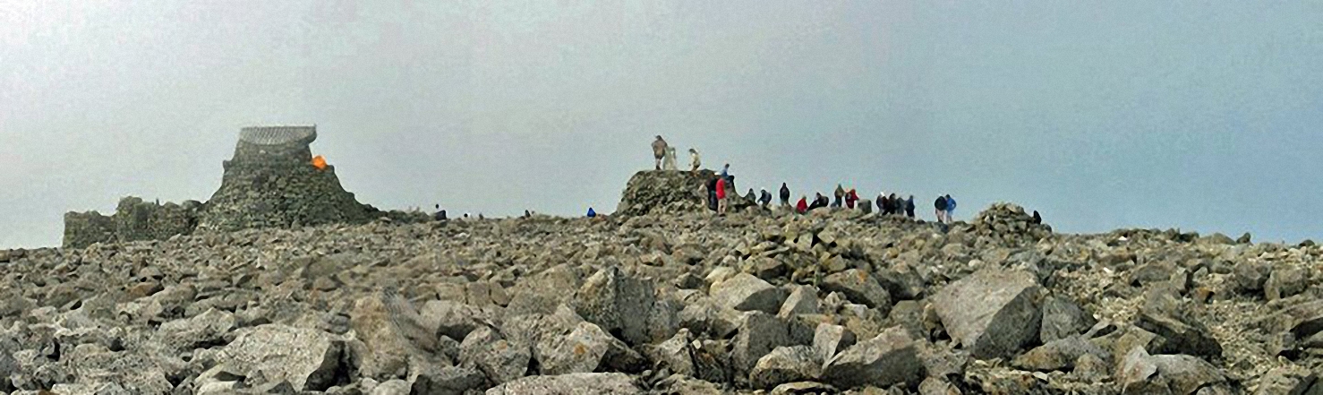 Walk h137 Ben Nevis and Carn Mor Dearg from Achintee, Fort William - My daughter and friend, climbing up the summit cairn at the top of Ben Nevis