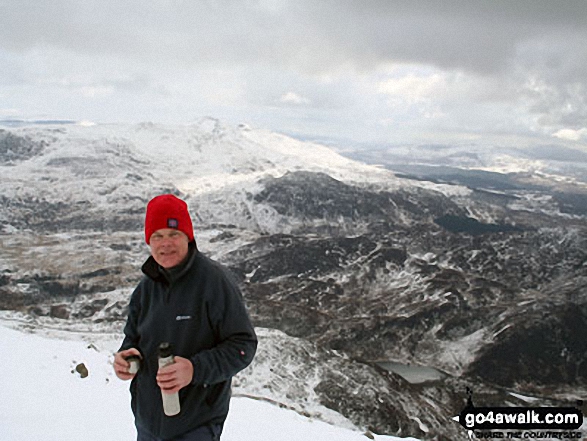 Walk gw117 Snowdon and Yr Aran via The Watkin Path from Bathania, Nantgwynant - My dad on the summit of Yr Aran in the snow with Cnicht & Moelwyn Mawr on the horizon (left centre) and Lyn Dinas in the Nantgwynant valley below (right)