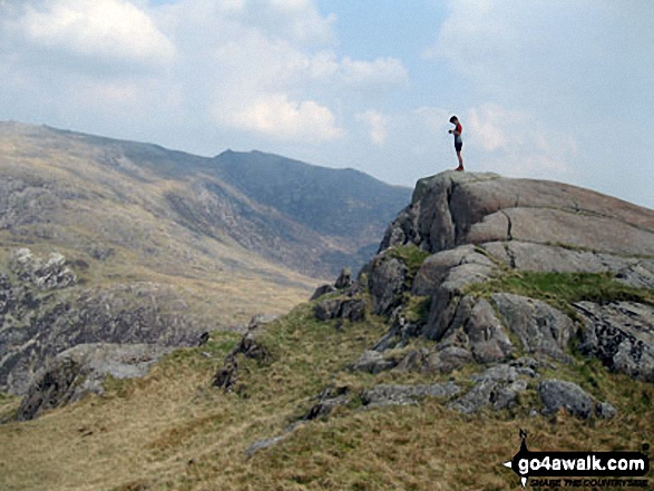 Walk gw153 Crib Goch from Pen y Pass - Roman standing in the summit of Craig Fach with Glyder Fawr forming the horizon