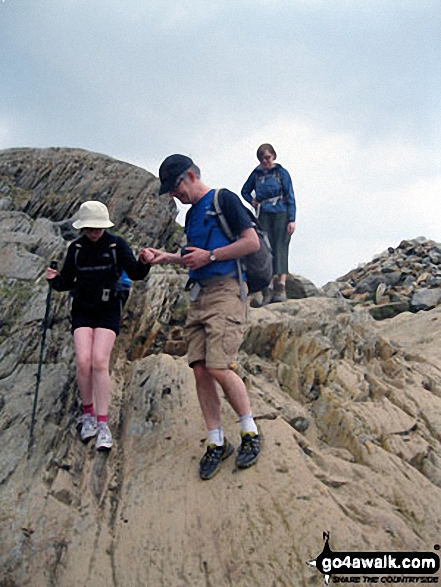 Walk gw153 Crib Goch from Pen y Pass - Andy and Nell negotiating a tricky section of the PYG Track up Mount Snowdon. Tess waits her turn.