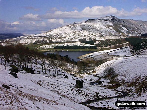 A snowy Dovestone Reservoir with Dick Hill beyond from Chew Brook 