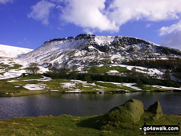 Dove Stone Reservoir with snow on Great Dove Stone Rocks beyond 