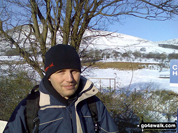 Walk d252 Mam Tor and Rushup Edge from Edale - Carl Morris at a snowy Edale Station with Grindslow Knoll (Kinder Scout) in the background