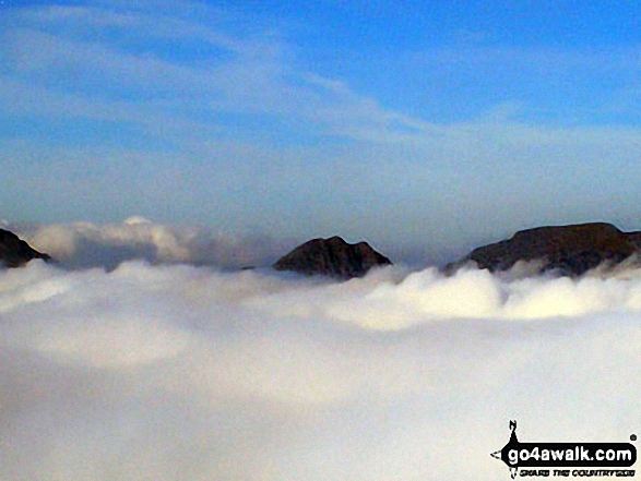 Walk cw108 Carnedd Moel Siabod from Plas y Brenin, Capel Curig - The Glyderau (Glyderau) (left), Tryfan and Carrnedd Dafydd (The Carneddau) poking through low cloud from the summit of Carnedd Moel Siabod