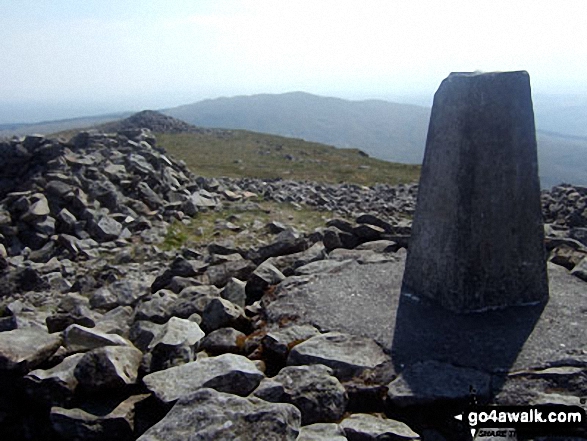 Pen Pumlumon Fawr (Plynlimon) summit trig point with Y Garn (Pumlumon) in the distance 