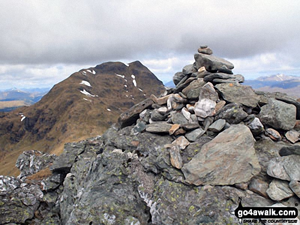 The summit cairn on Beinn Tulaichean with Cruach Ardrain in the background