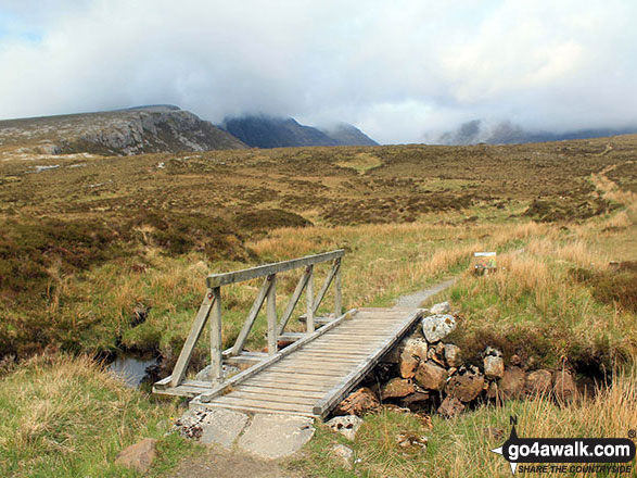 Footbridge at Lairig Unapool with Spidean Coinich (Quinag) shrouded in mist on the horizon