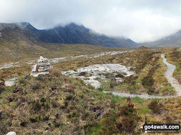 Walk h197 Spidean Coinich (Quinag), Sail Ghorm (Quinag) and Sail Gharbh (Quinag) from Lairig Unapool - Cairn beside the path in Lairig Unapool with a mist topped Spidean Coinich (Quinag) centre left