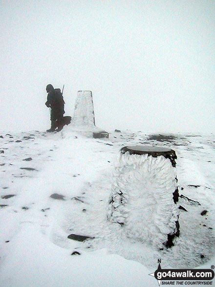 Walk c321 Skiddaw and Lonscale Fell from Millbeck, nr Keswick - The trig point and viewpoint indicator on the summit of a very cold and snowy Skiddaw