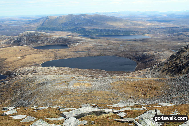 Loch a' Ghobha-Duibh (centre), Dubh-Loch Creige Riabhaich and Meallan Liach (left) with Loch an Dherue and An Caisteal (Ben Loyal) (in the distance) from the summit of Ben Hope 