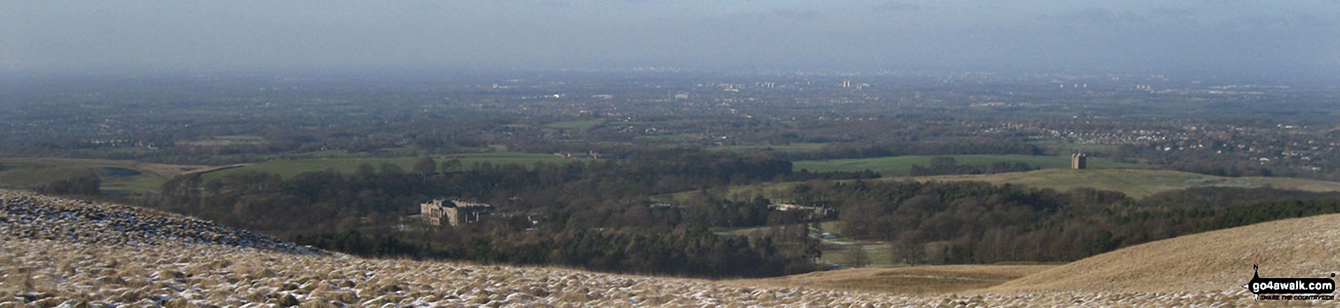 Walk ch310 West Parkgate, Sponds Hill and The Cage from Lyme Park Country Park - Lyme Hall (left) and The Cage (right) with Manchester and Stockport beyond from the memorial in Lyme Park Country Park just north of Bowstonegate Farm