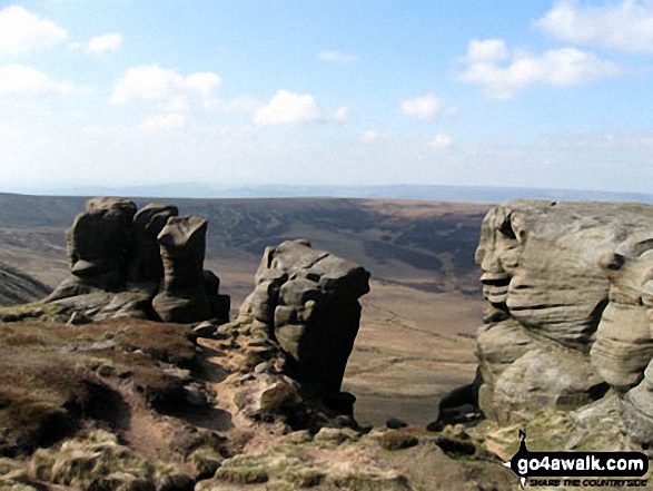 Rock formations on the northern edge of Kinder Scout with Featherbed Moss over Black Ashop Moor in the background. 