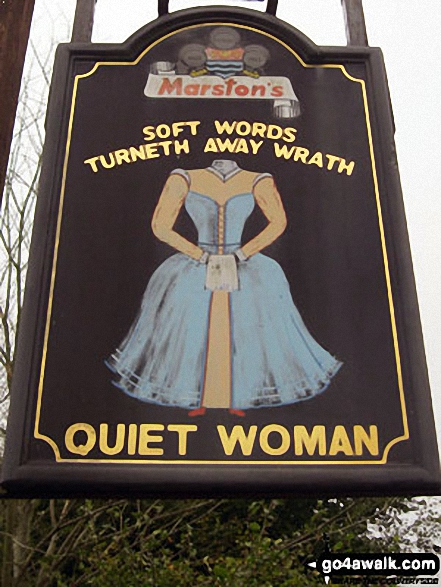 Sign for the Quiet Woman pub in Earl Sterndale. Soft Words Turneth Away Wrath. Indeed