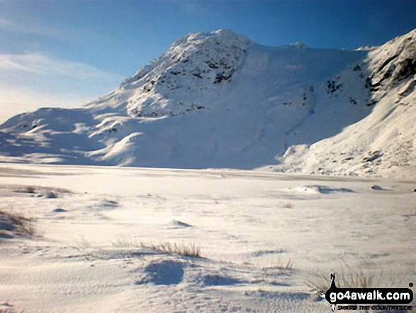 Snow on Harrison Stickle across a frozen Stickle Tarn