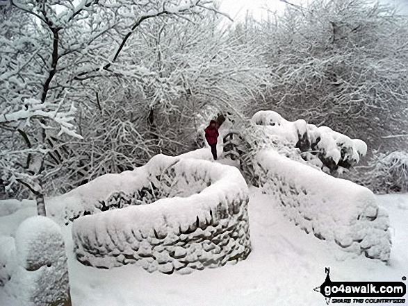 Footbridge under a deep layer of snow in Little Hayfield 