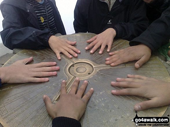 My oldest sons (14 and 15 years old) and some of their mates get hands on at the cairn, on top of Mount Snowdon after doing a charity walk.