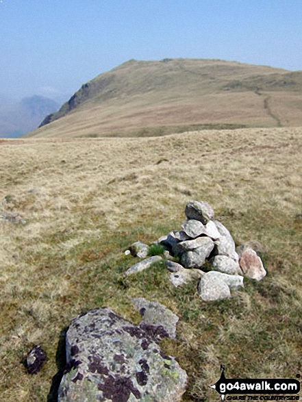 Irton Fell summit cairn with Whin Rigg in the background