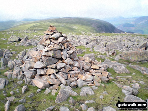 Caw Fell summit cairn with Iron Crag beyond