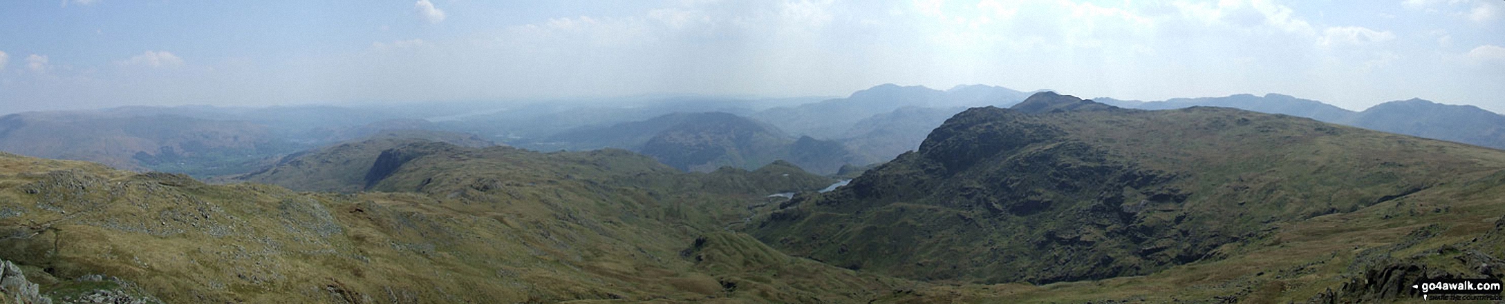 Walk c208 Harrison Stickle and High Raise from The New Dungeon Ghyll, Great Langdale - *The view from Sergeant Man featuring Blea Rigg (centre left), Lingmoor Fell (centre distance), Stickle Tarn (partially hidden) and Pavey Ark with Harrison Stickle beyond (The Langdale Pikes) (centre right)