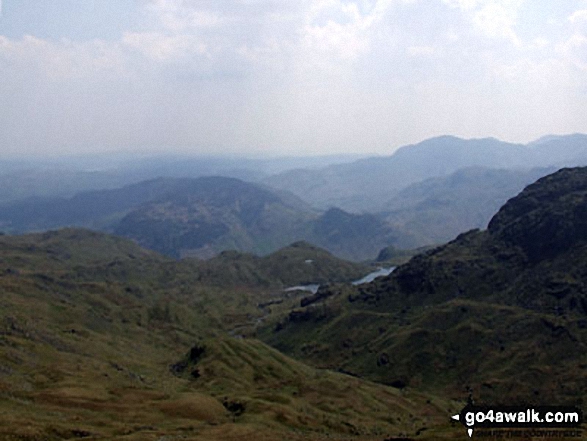 The view from Sergeant Man featuring Blea Rigg (centre left),Lingmoor Fell (distance centre), Stickle Tarn (partially hidden) and the shoulder of Pavey Ark (The Langdale Pikes) (right) 