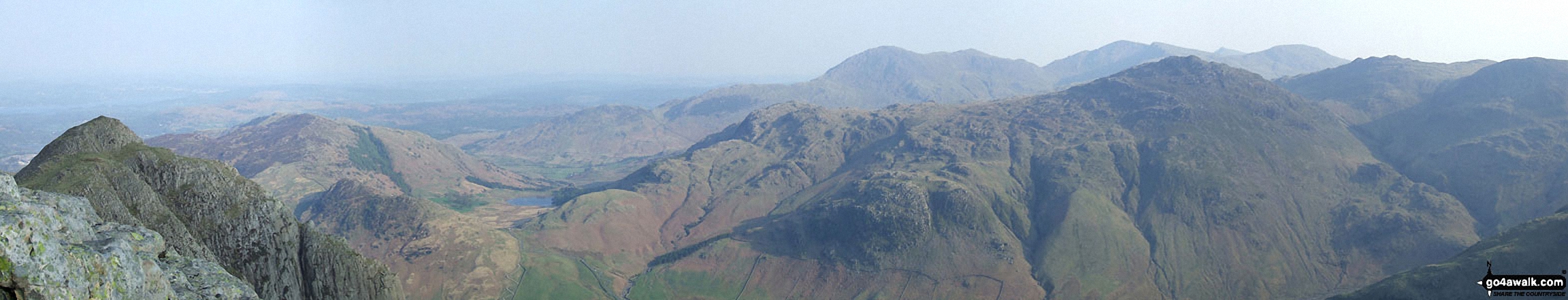 Walk c418 The Langdale Pikes via North Rake and Rossett Pike from Great Langdale - *Loft Crag (foreground far left), Lingmoor, Blea Tarn, Pike of Blisco (Pike o' Blisco), Cold Pike and Crinkle Crags (featuring Crinkle Crags (South Top), Crinkle Crags (Long Top) and Gunson Knott) (mid-distance left to right) and Wetherlam, Great Carrs and Grey Friar (far-distance centre to right)  from the summit of Pike of Stickle (Langdale Pikes)