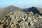 The rocky summit of Hopegill Head with Hobcarton Crag and Grisedale Pike beyond