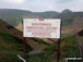 Harley Dingle/New Radnor Firing Range Warning sign below Three Riggles with Black Mixen, Bache Hill and Whimble on the horizon, Radnor Forest