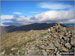 White Maiden summit cairn with Grey Friar (left), Dow Crag, Brown Pike and The Old Man of Coniston (right) in the background